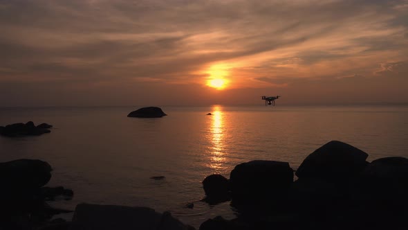 Drone flying above the sea in beautiful twilight sunset