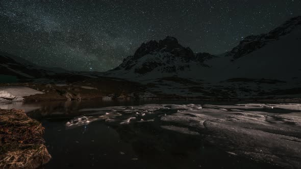 Timelapse of Milky Way Above the Snow-capped Mountains and Lake with Ice Floes  alt