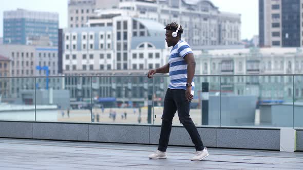 Active Black Male Dancing Afrobeat Style in City alt