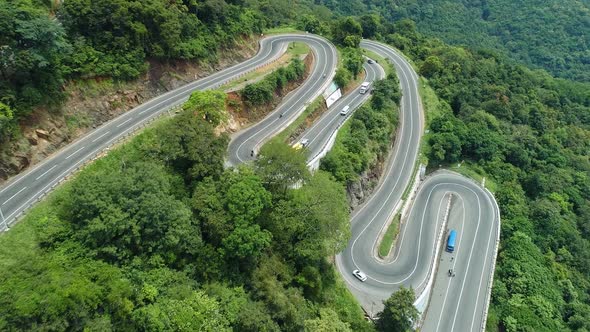 Flyover Vehicles On A Winding Bend Road alt