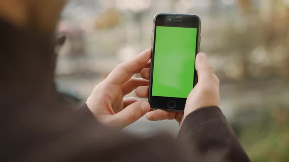 Man Hands Holding Cellphone Green Screen, Guy Looking Phone Chroma Key Screen alt