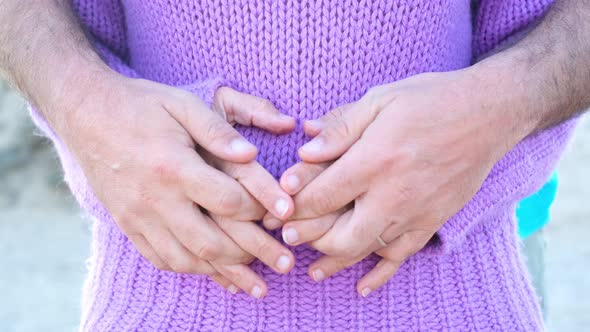Close up of two pair of couple hands touching and caring each other against belly woman. love alt