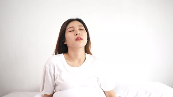 Asian young woman lying on bed and wake up in the morning alt