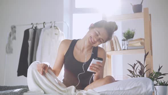 Caucasian Girl Listening Music Through Headphones and Smartphone in Slowmotion alt