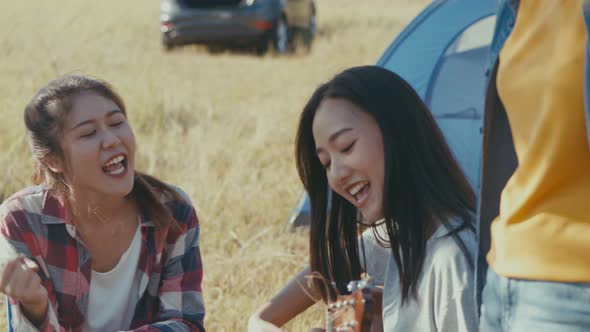 Group of a young teen Asian woman happy with friends camping in nature having fun together.