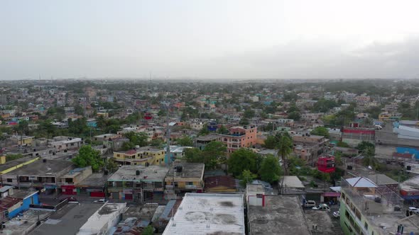 Drone Hovers Above Dirty Residential Rooftops in Santo Domingo as Red White and Blue Cable Cars (Tel alt