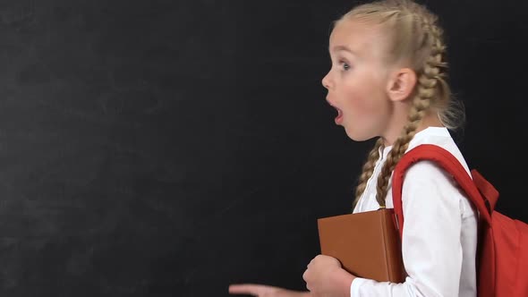 Excited Girl Pointing Finger Into Blackboard, School Lessons, Template for Text alt