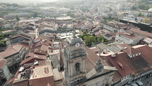 Church bell tower with a clock close up, aerial view of catholic architecture in Guimaraes Portugal