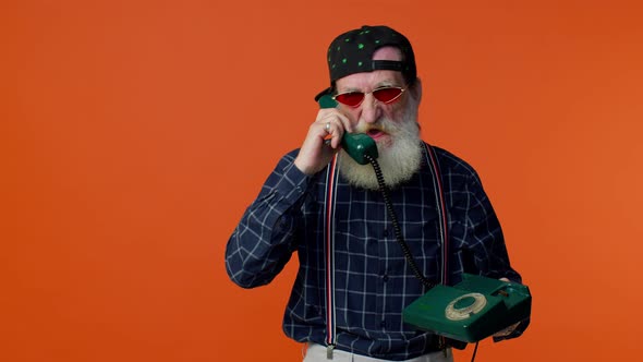 Crazy Elderly Bearded Old Man Talking on Wired Vintage Telephone of 80s Fooling Making Silly Faces alt