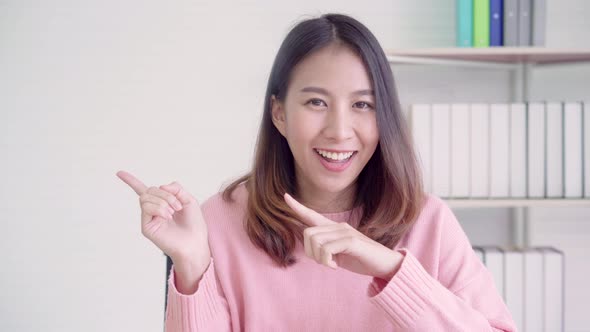 Asian friendly businesswoman speaker looking at camera and talking podcast on video shooting. alt