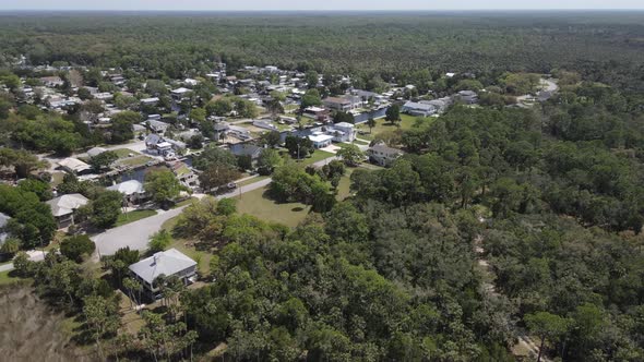 fast spin aerial from the marsh lands of the Weeki Wachee River to the Weeki Wachee Gardens subdivis alt