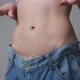 Young Woman Shows her Weight Loss and Wearing Her Old Jeans - VideoHive Item for Sale