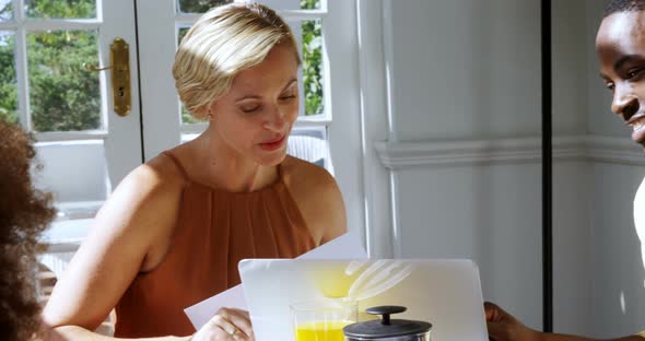 Executive discussing over laptop in restaurant alt