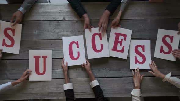 Business people put SUCCESS letters