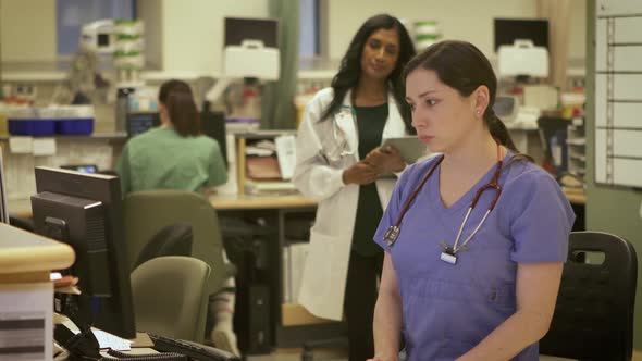 Nurses and Doctors working together in a modern busy hospital. alt