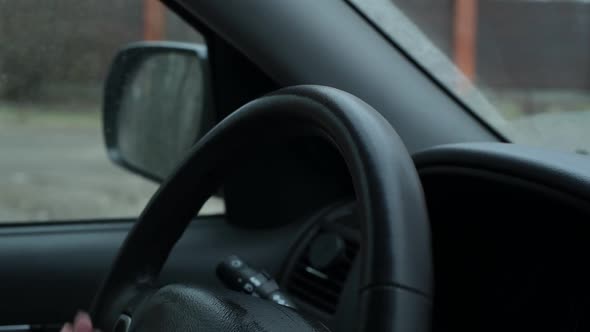 girl wipes a car steering wheel with an antibacterial wipe during a pandemic alt