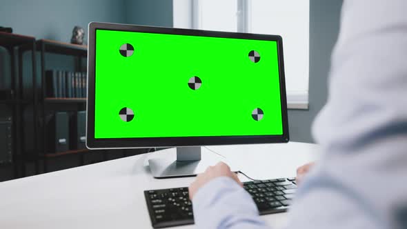 Woman Having Video Chat on Computer with Green Screen alt