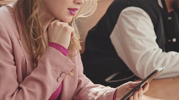 Female Student Scrolling through Smartphone in Class alt