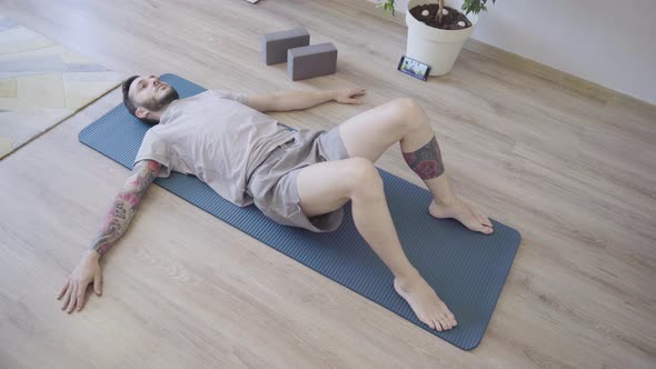 Young Man Practicing Relaxing Yoga Poses at Home for Healthy Lifestyle alt
