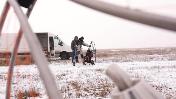 Men Starts To Work a Propeller Motor Engine of the Paramotor Paraglider alt