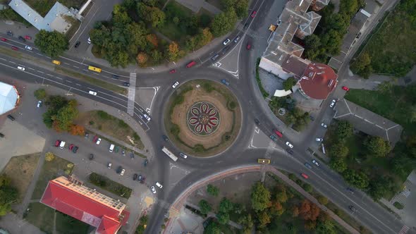  Aerial View of Roundabout Road with Circular Cars in Small European City at Summer Day alt