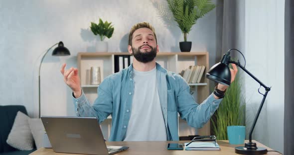 Man which Sitting at His Workplace at Home and Meditating with Closed Eyes to Enjoy Harmony alt