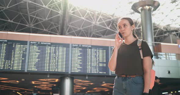A Woman at the Airport on the Phone Discussing the Delay of His Flight alt