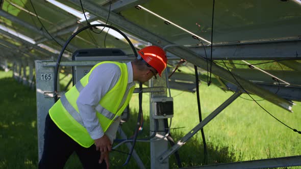 Engineer in a Special Equipment is at the Solar Power Station