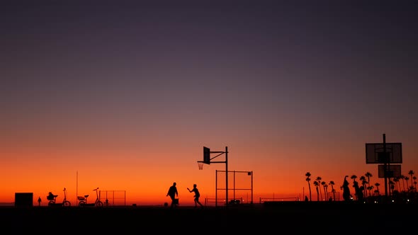 California Summertime Dusk Beach Aesthetic, Pink Sunset. Unrecognizable Silhouettes, People Play