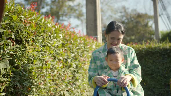 happiness cheerful asian male child play fun relax leisure weekend at park playground alt