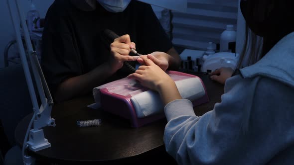 Anonymous Beautician Doing Manicure to Female Client