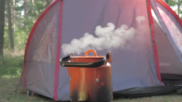 A Red Camping Tent on the Back of the Stove
