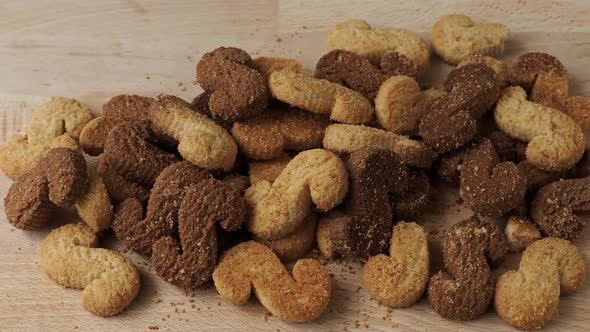 Esse biscuits. S cookies on wooden cutting board. Patterned biscuits.