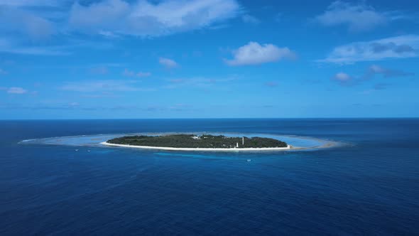 Moving high view of Lady Elliot Island looking across the water of the pacific ocean. Drone view alt