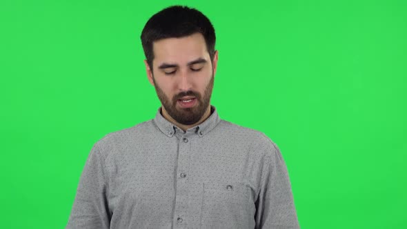 Portrait of Brunette Guy Is Refusing Stress and Taking Situation, Calming Down. Green Screen alt