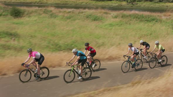 Group of cyclists on scenic country road.  Fully released for commercial use.