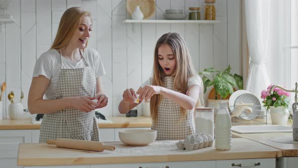 Teenager Girl Daughter Child and Cheerful Mother Woman Babysitter Maid Family Break Eggs Into Bowl alt