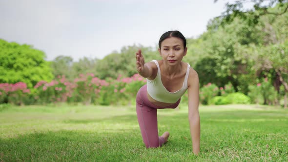 Beautiful Asian woman doing yoga exercises in the garden.