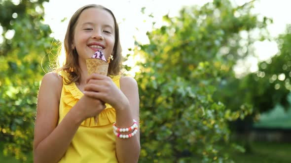 Cute girl with braces eating italian ice cream cone