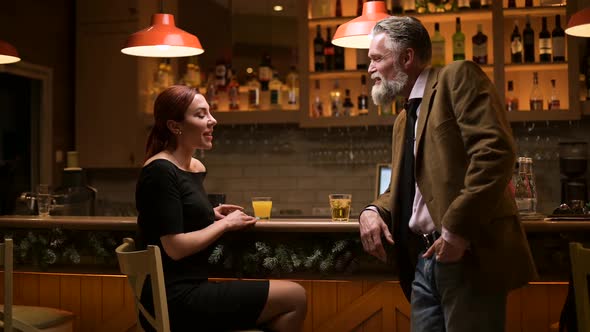 An adult respectable man meets a young woman in a bar and takes her phone number alt