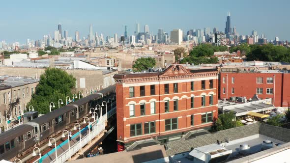 A slow dolly zoom shot of the distant Chicago skyline behind an old motel beside a rail train statio alt