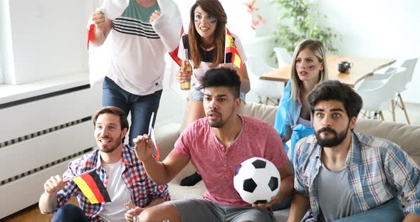 Happy Friends or Football Fans Watching Soccer on Tv and Celebrating Victory at Home