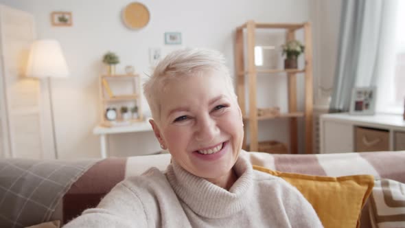 Mature Caucasian Lady Chatting on Video Call at Home alt