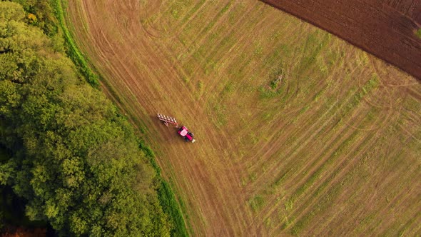 red tractor on green farm field view from above  alt