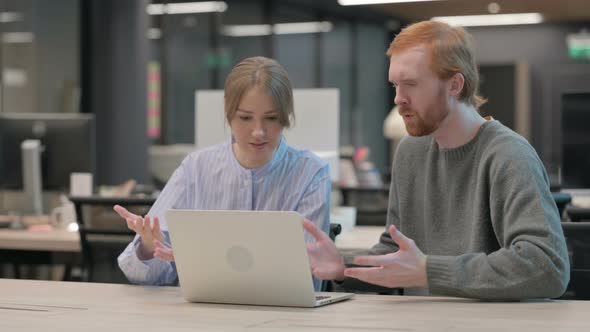 Young Man and Woman Reacting to Loss on Laptop alt
