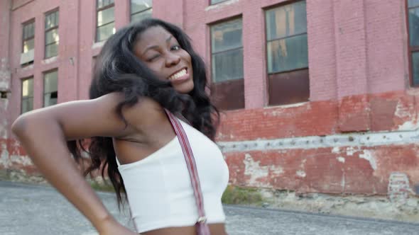 Young Black Girl Dancing On The Street. alt