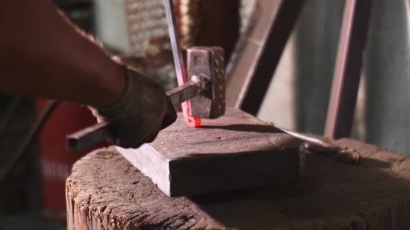Blacksmith Works Hit Hammer Hot Metal Bar to Bend It on Anvil in Forge Workshop