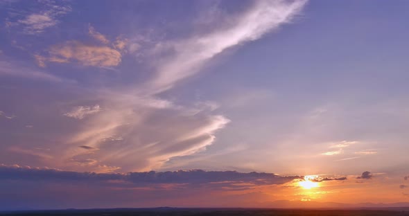 Through the Clouds the Sun Creates a Beautiful Orange Light Sunset alt