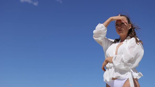 Sensual Woman in White Wear Enjoying Breeze