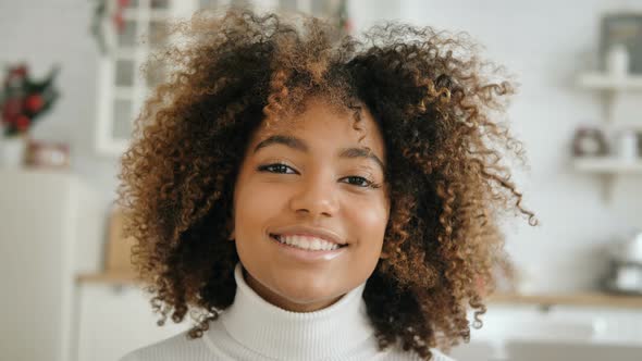Nice Dark Skinned Model Looks Into Camera Smiling Widely alt